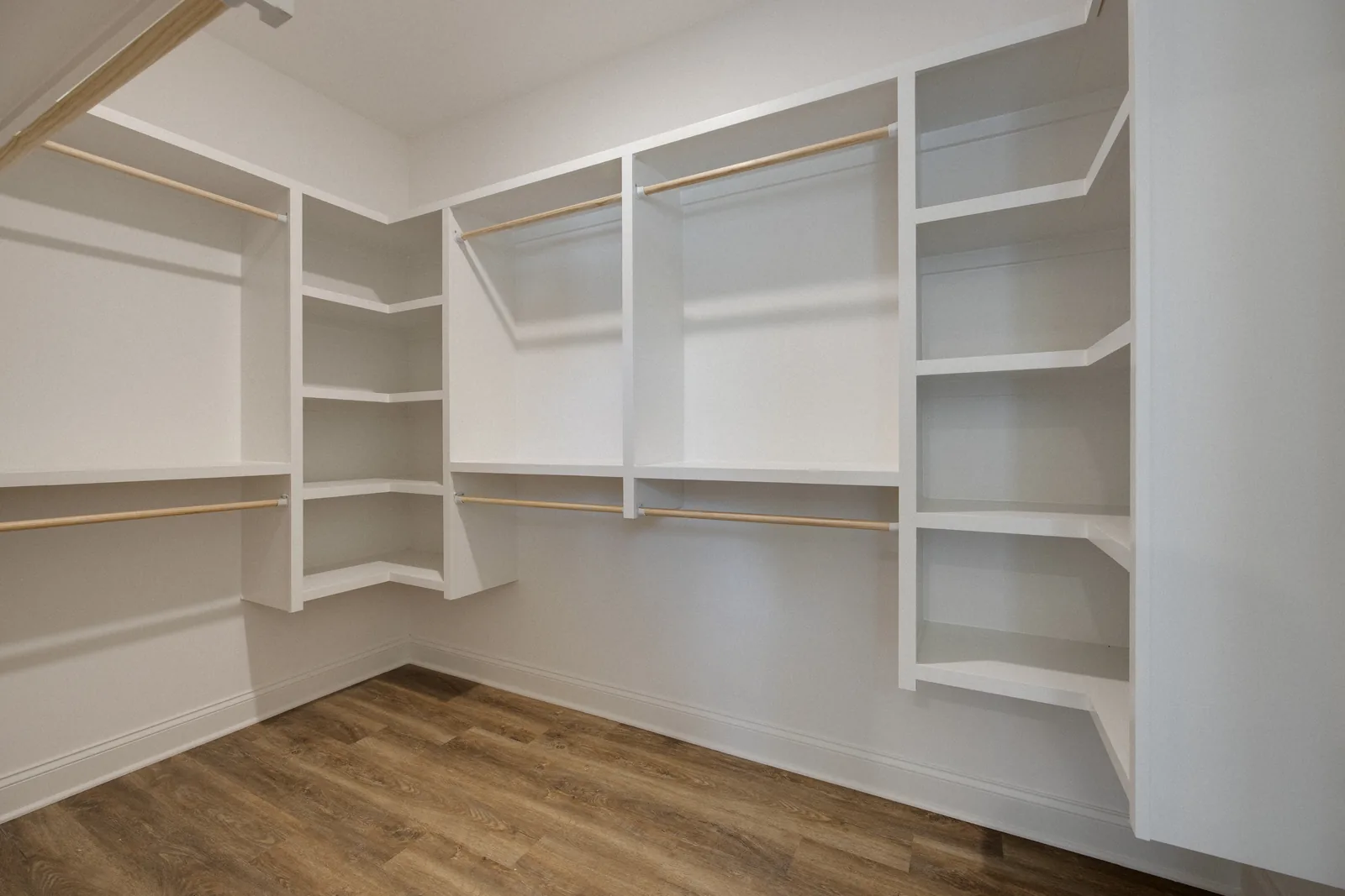 Walk-in closet with built-in shelving and hanging rods