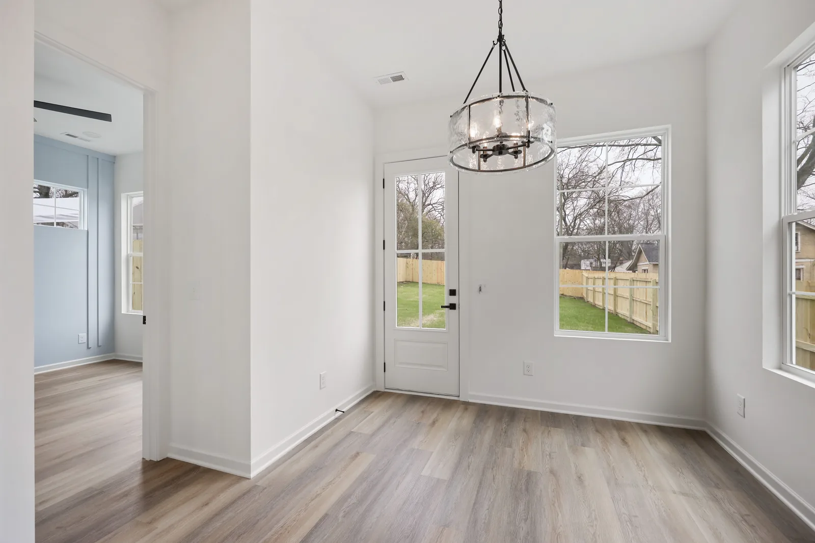 Entry with a glass front door and a ring chandelier