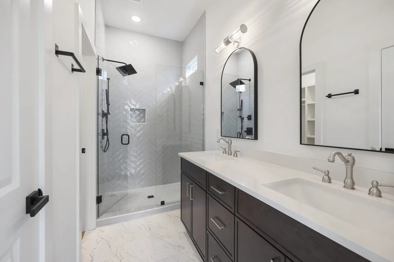 Primary bath with a glass shower and double vanity