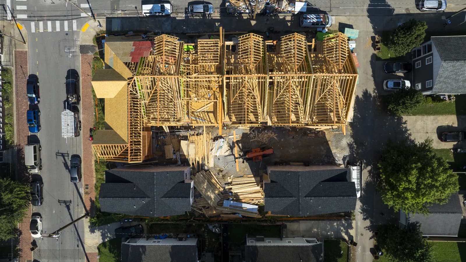 Top-down view over the framed townhomes and the street below