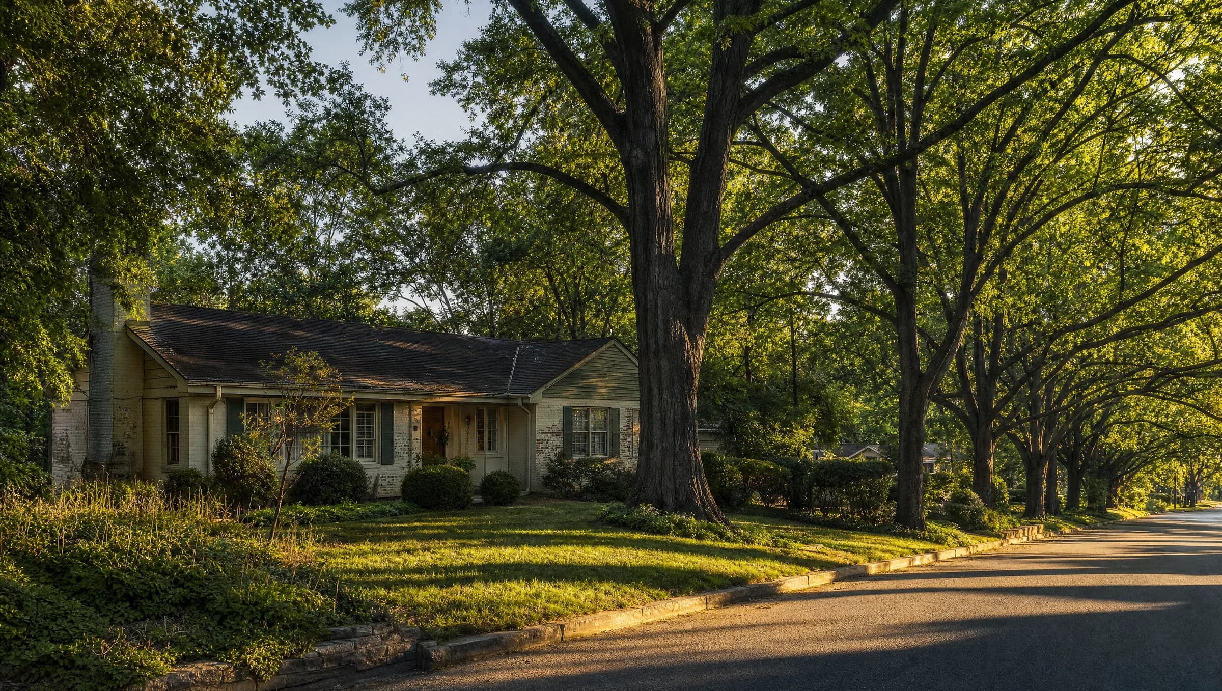 An aging single-story home on an established tree-lined Nashville street — the kind of property May Construction quietly acquires