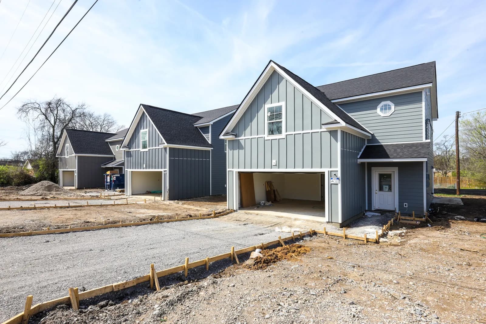 Street view of a Forest Park home during construction, driveway forms staked out