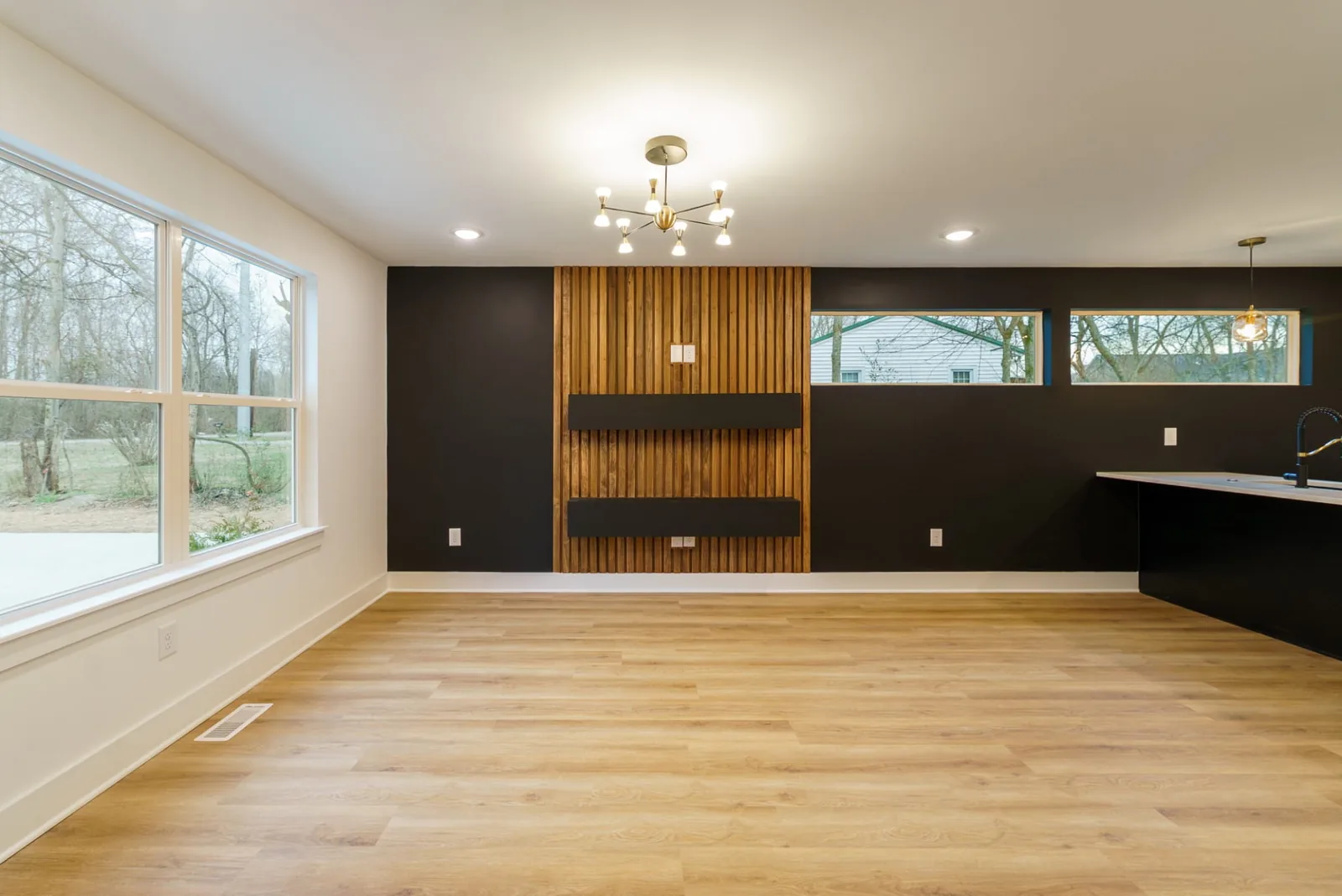 Living room with a wood-slat feature wall set into deep charcoal paint