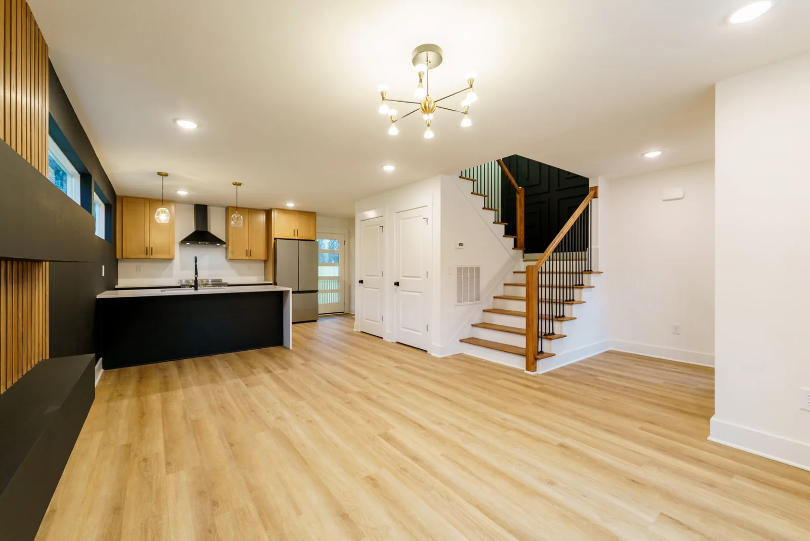 Open living area and the oak staircase beyond the kitchen