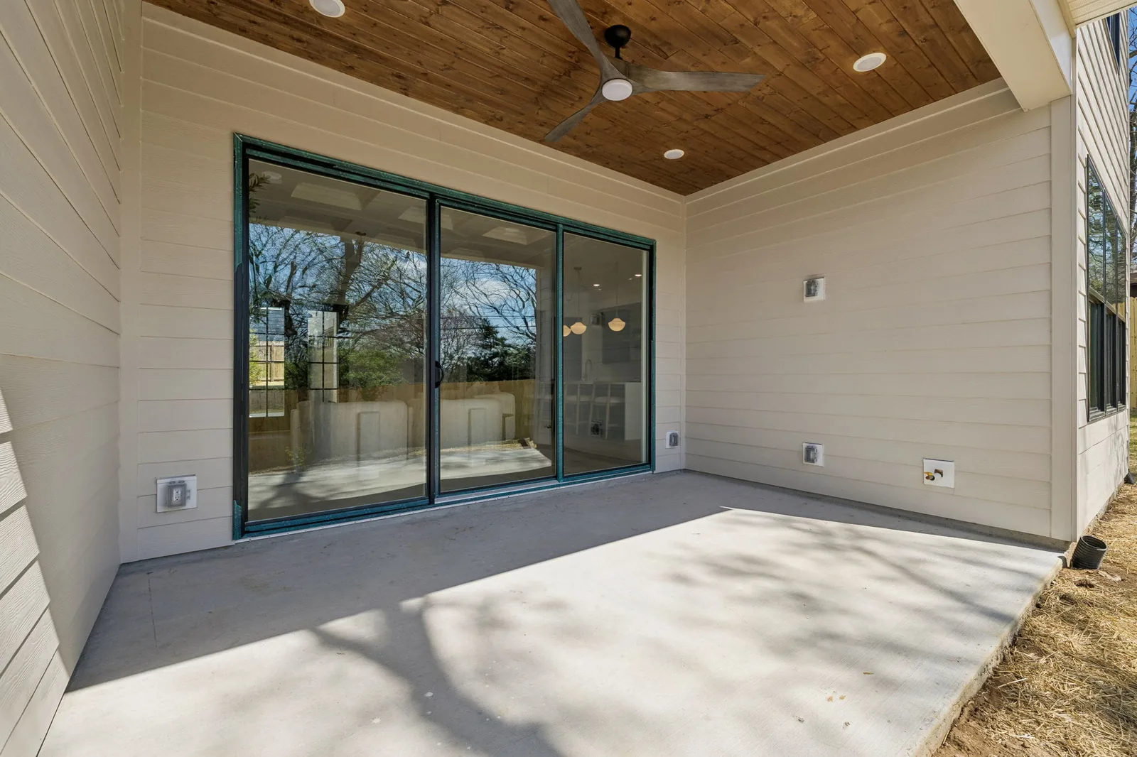 Covered porch at 621B Westboro Dr with a stained tongue-and-groove ceiling, a ceiling fan, and full-height glass sliders